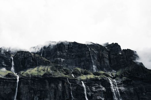 Majestic waterfalls cascade down rugged cliffs in Sixt-Fer-à-Cheval, France.