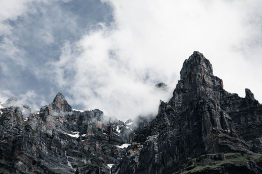 Explore the dramatic rocky peaks of Sixt-Fer-à-Cheval, France under mysterious cloud cover.