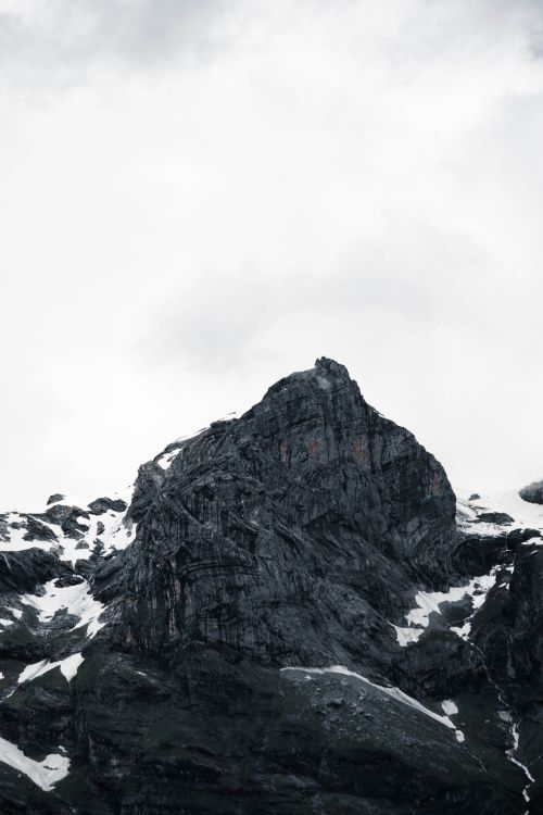 Free Snow-capped mountains of Sixt-Fer-à-Cheval under cloudy skies, offering a dramatic nature view. Stock Photo
