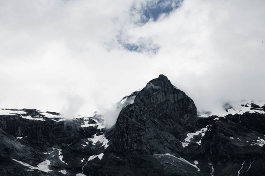 Stunning view of rugged mountain peaks and clouds in Sixt-Fer-à-Cheval, France.