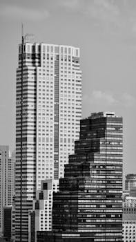 Striking black and white image of Bangkok's urban skyscrapers against the sky.