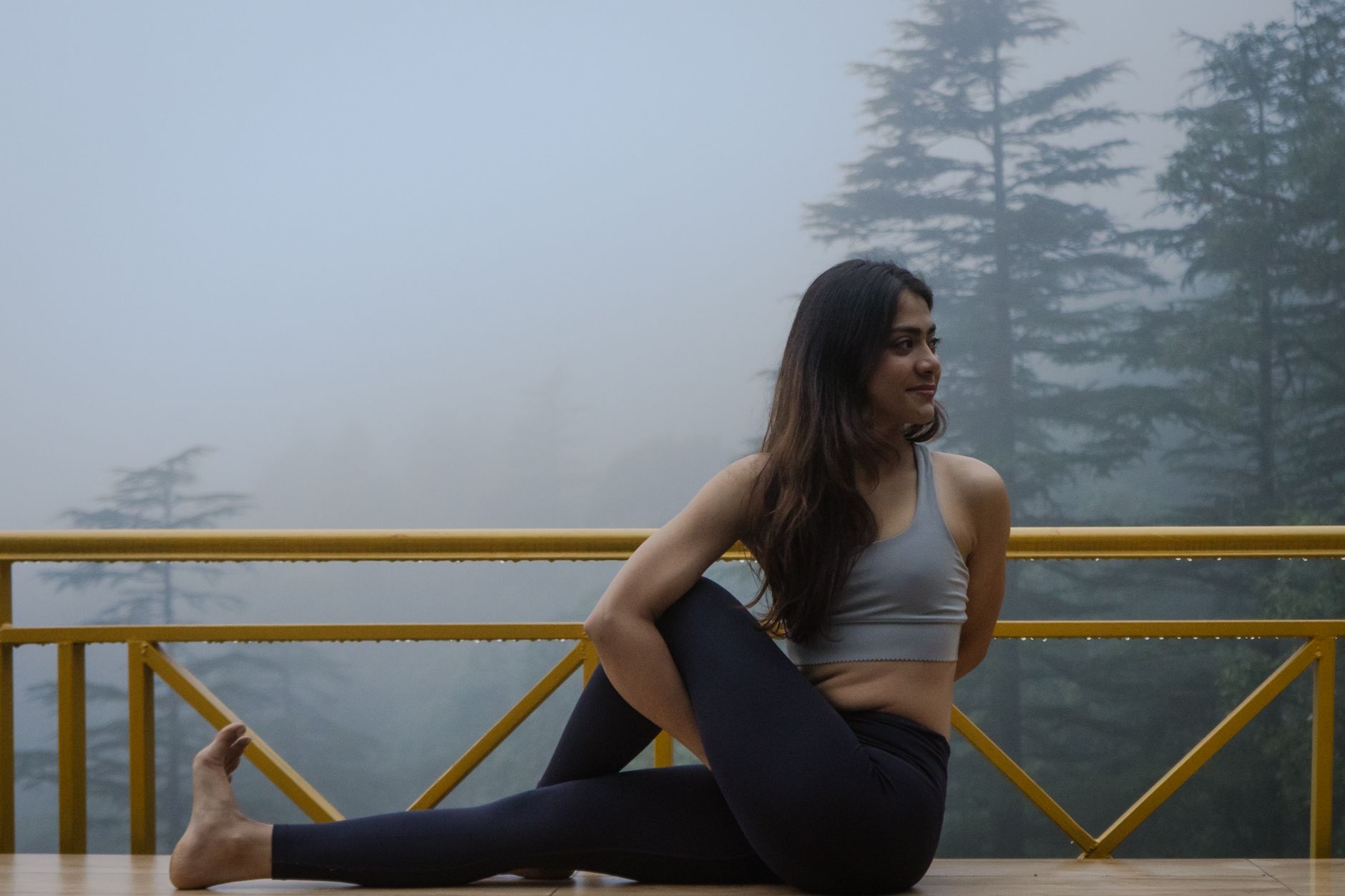Person practicing yoga pranayama in the morning sunlight for gut health and stress relief