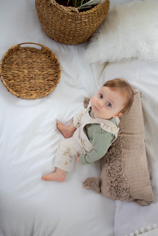 Free Little Child Sitting on Sofa  Stock Photo