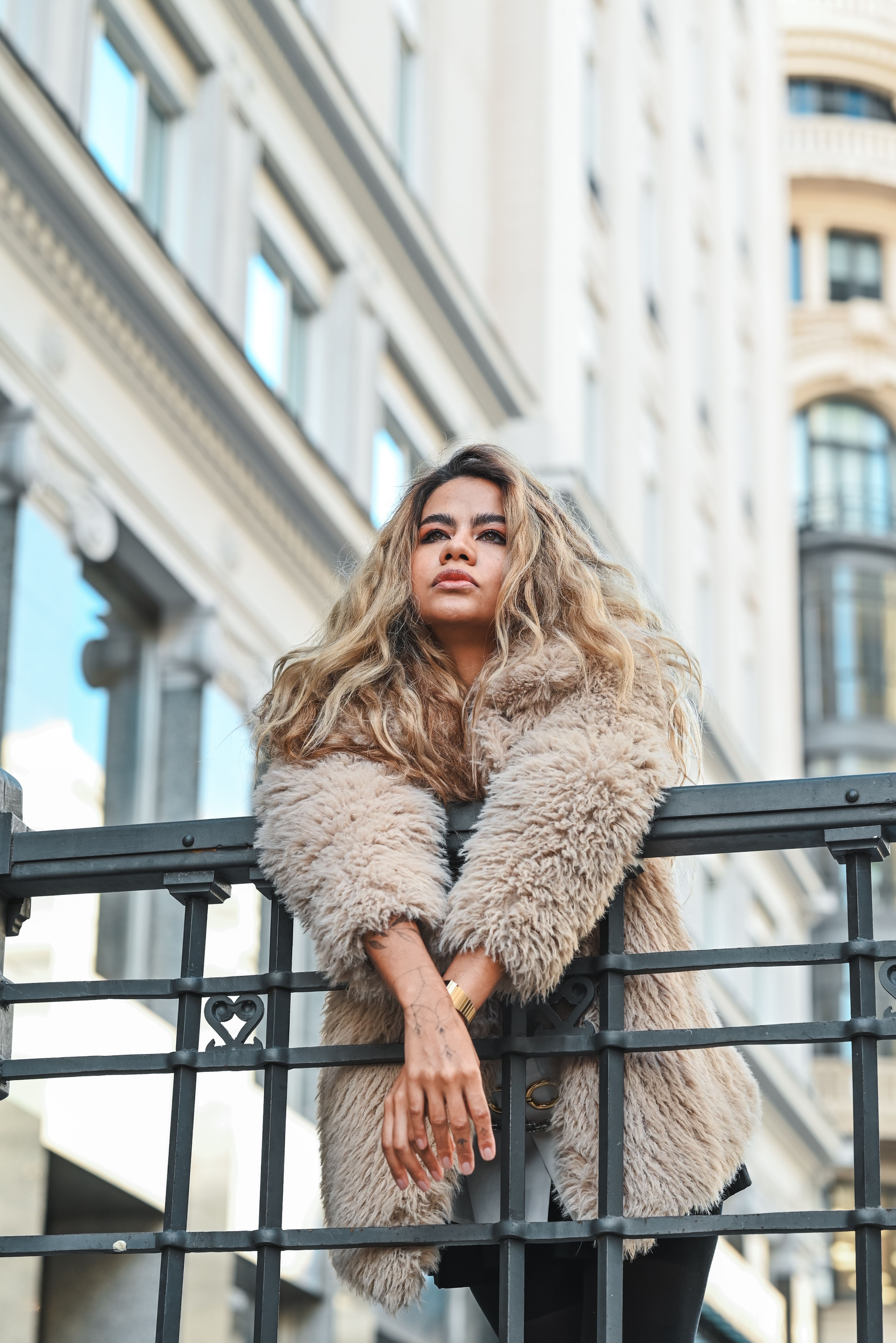 A Young Woman in a Coat Posing by the Building in a City · Free Stock Photo