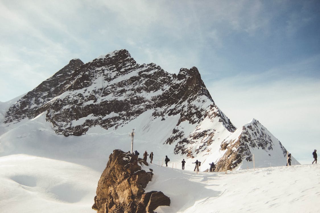 People Walking on Snowy Mountain