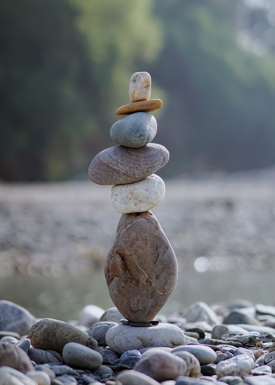 Pebbles Stacked on River Bank · Free Stock Photo