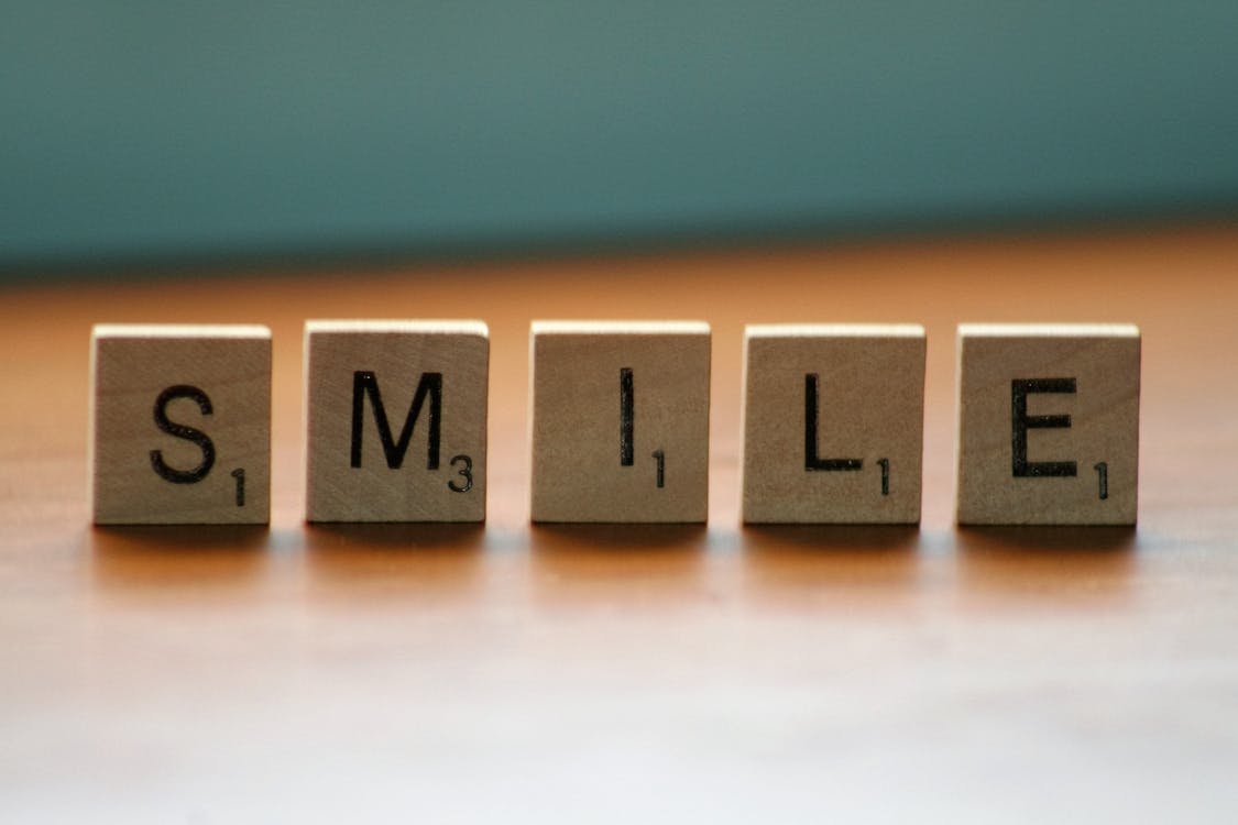Close Up Photography of Wooden Blocks With Smile Text