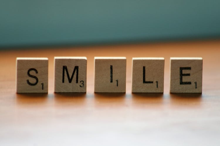 Close Up Photography Of Wooden Blocks With Smile Text