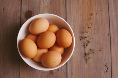 Brown eggs in a white bowl on a wooden table. Photo by kendra coupland on Pexels