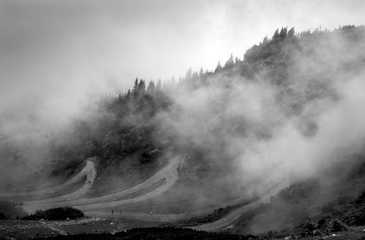 A foggy mountain landscape featuring winding roads near Innsbruck, Austria.