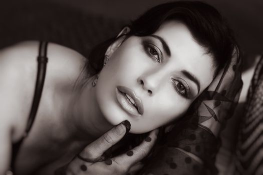 Close-up monochromatic portrait of a glamorous woman with gloves, adding a sensual and artistic touch.