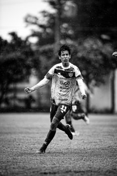 Shot of a soccer player in action in Paraguay, captured in dramatic black and white.