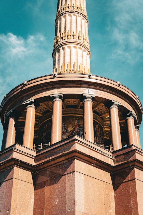 The top of a tall building with a clock tower