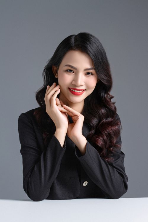 Free Portrait of a stylish woman in a black shirt posing confidently in a studio setting. Stock Photo