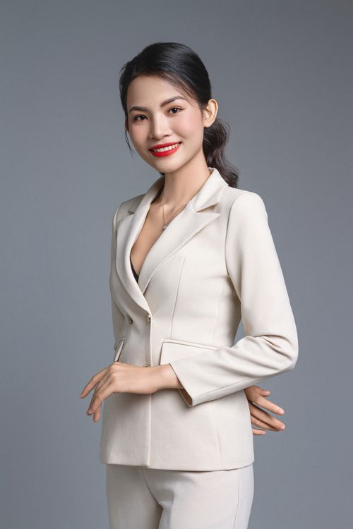 Free Confident businesswoman in a white suit posing for a studio portrait. Stock Photo