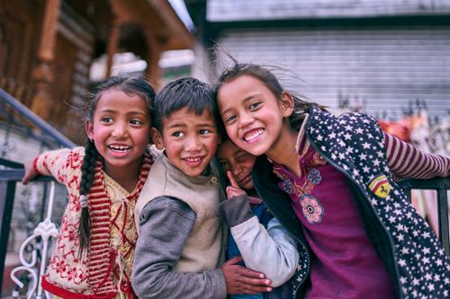 Free Happy children enjoy a group hug outdoors, showcasing a strong bond and friendship. Stock Photo