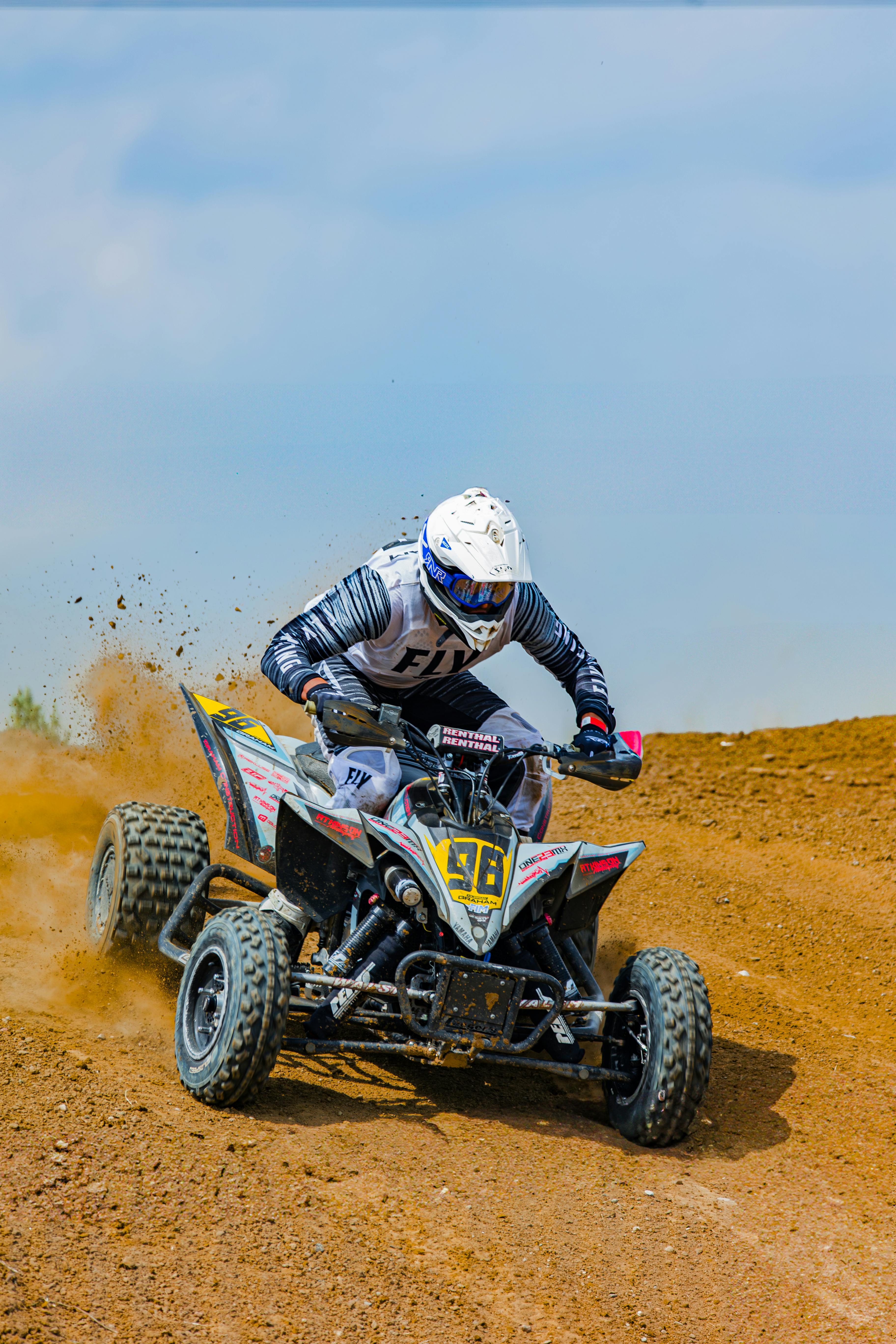 man driving quad bike on sand