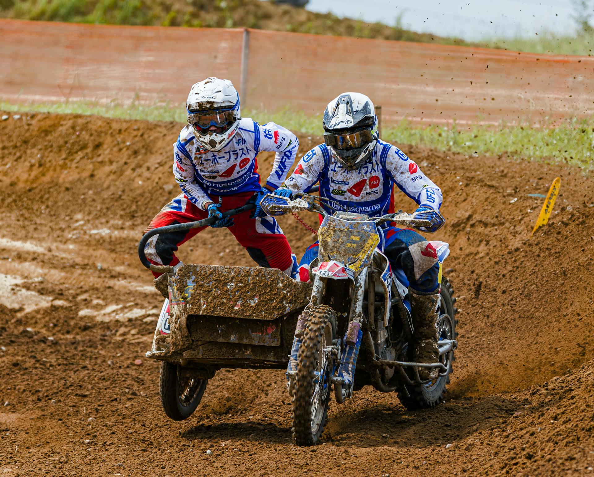 Motorcyclists Riding on Tandem Cross Bike on Mud Together