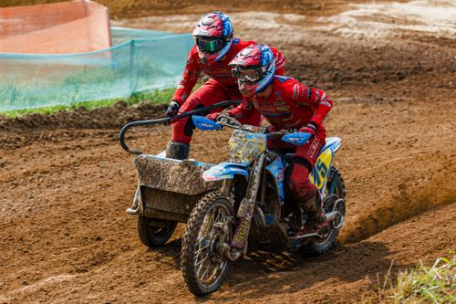 Free Exciting sidecar motocross racing action on a challenging dirt track outdoors with two participants. Stock Photo