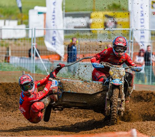 Free Dynamic sidecar motocross race with riders in action on a muddy track, showcasing skill and speed. Stock Photo