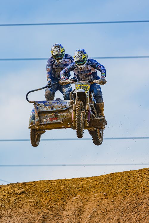 Free High-adrenaline sidecar motocross jump captured during an intense race, showcasing skill and speed. Stock Photo
