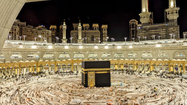 Saudi Arabia, Vibrant night view of the Kaaba in Mecca, capturing Islamic architecture and worshippers.