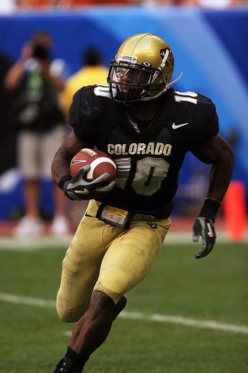 Selective Focus Photography of Man Playing American Football