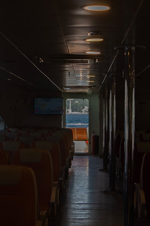 A view of a boat with many seats and a window