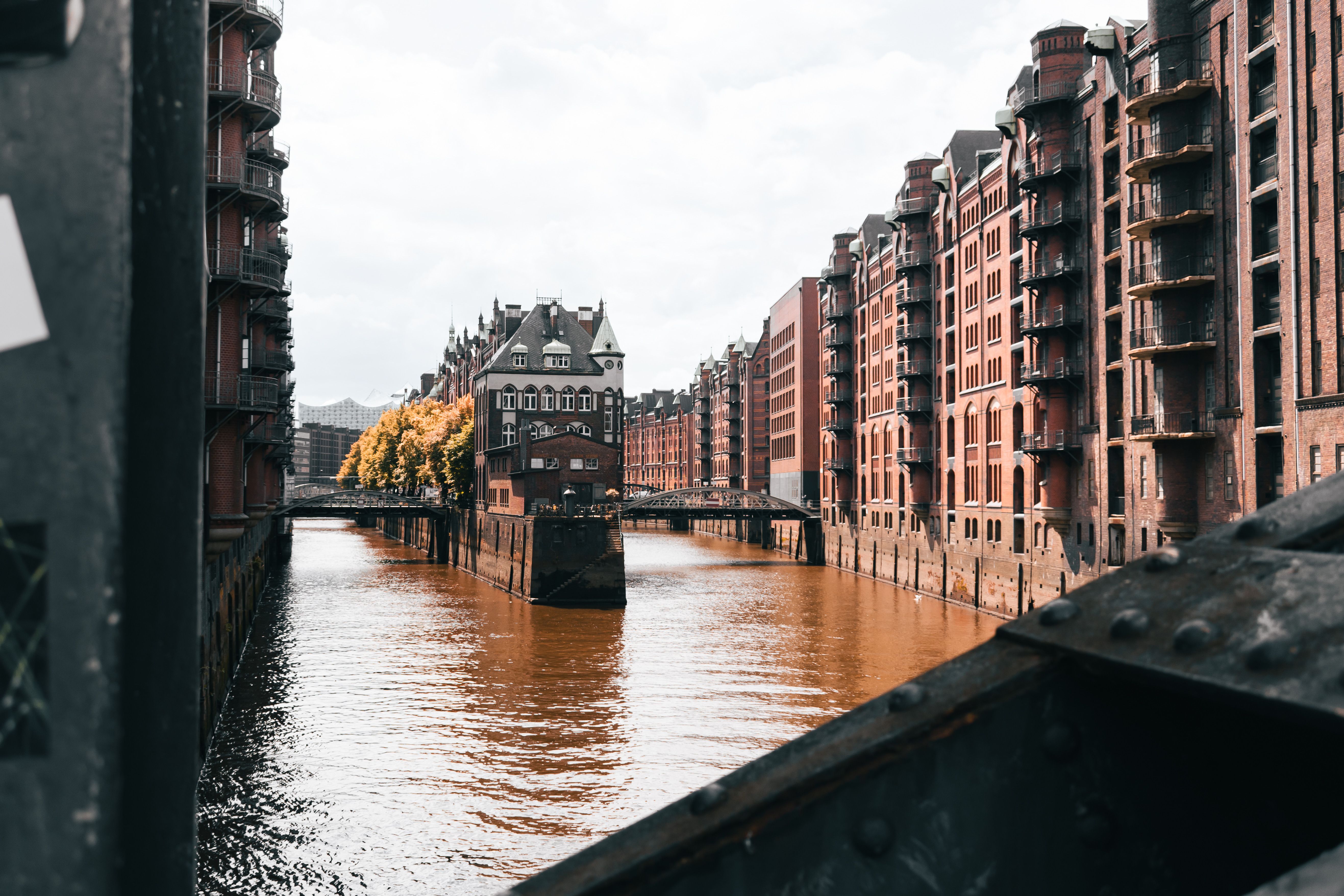 View of Speicherstadt's historic brick warehouses along the canal in Hamburg, Germany.