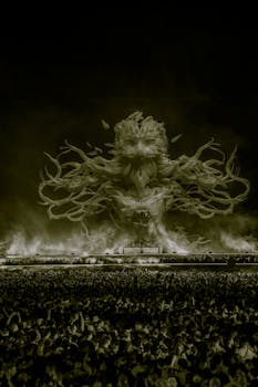 Epic nighttime concert featuring a mythical creature projection on stage with a vibrant crowd.