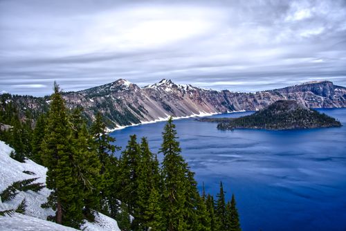 Free Stunning winter landscape of Crater Lake with clear blue waters and snowy surroundings in Oregon. Stock Photo