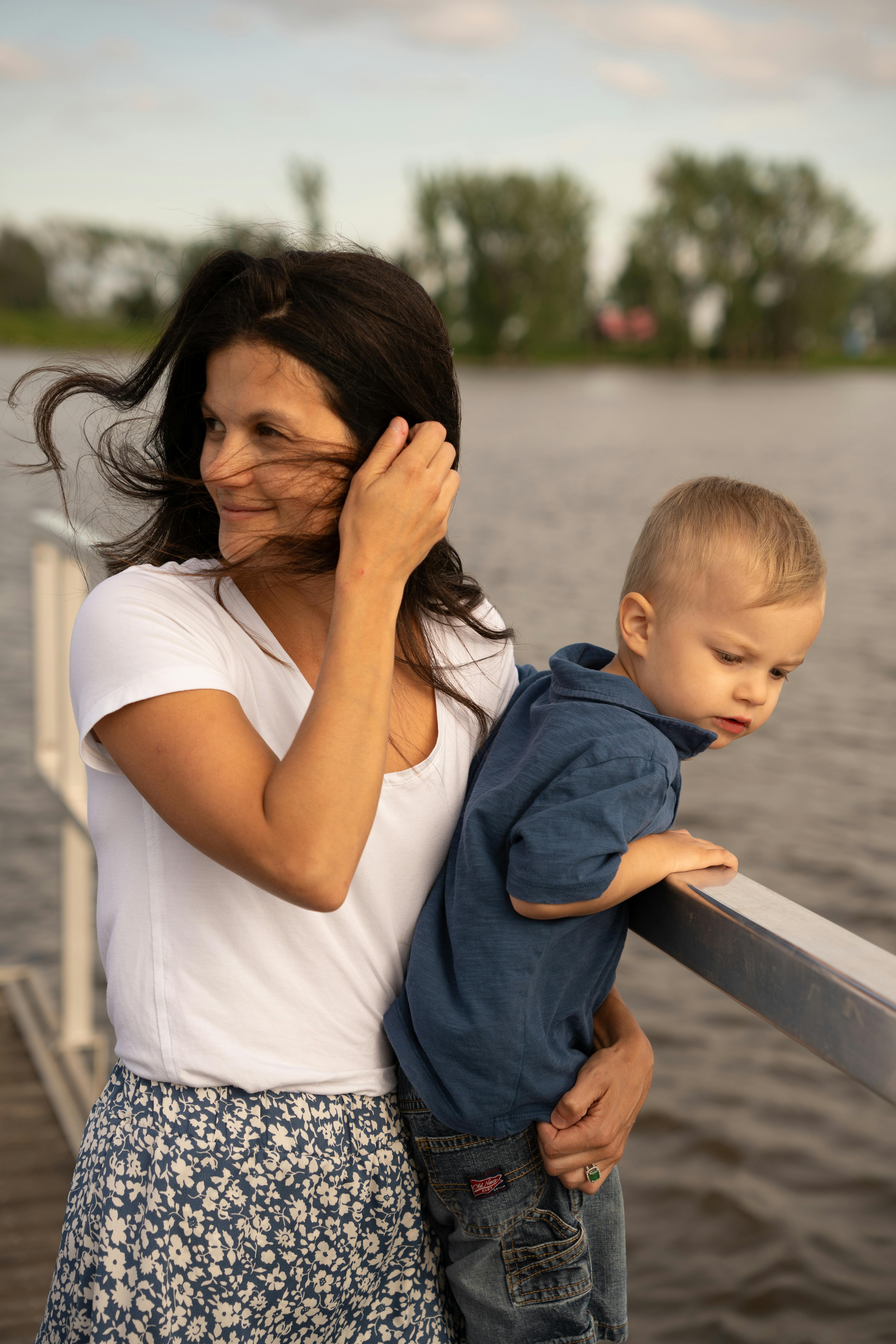 mother with boy by railing on river