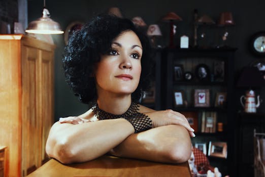 Elegant portrait of a woman in a cozy room, softly lit. Ideal for lifestyle themes.