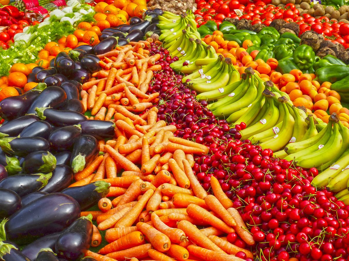 Fresh groceries including produce, bread, and pantry items arranged on a kitchen counter for delivery