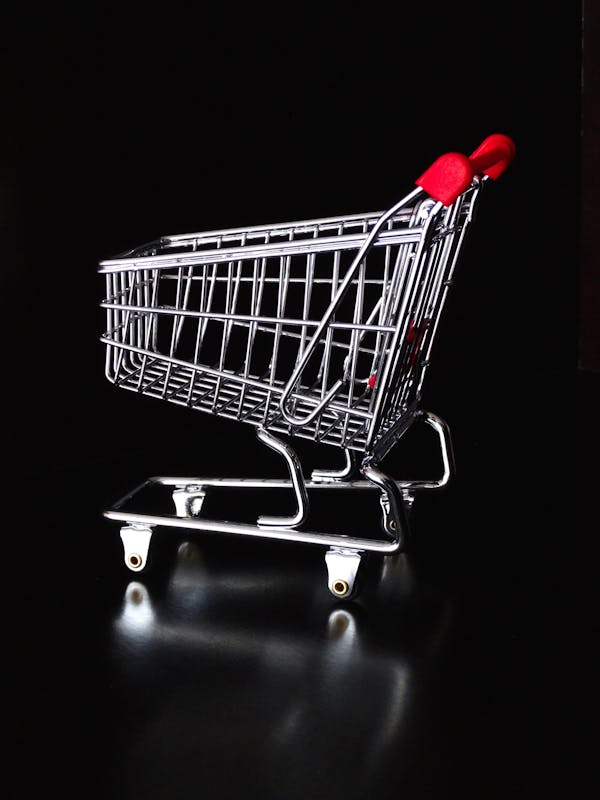 Red Handle Gray Shopping Cart on Black Background