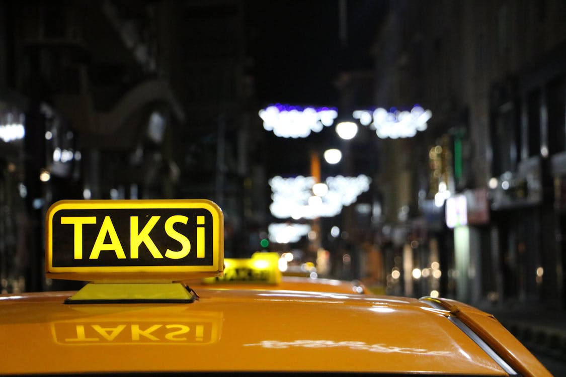Free Taksi Vehicle Between Buildings Stock Photo