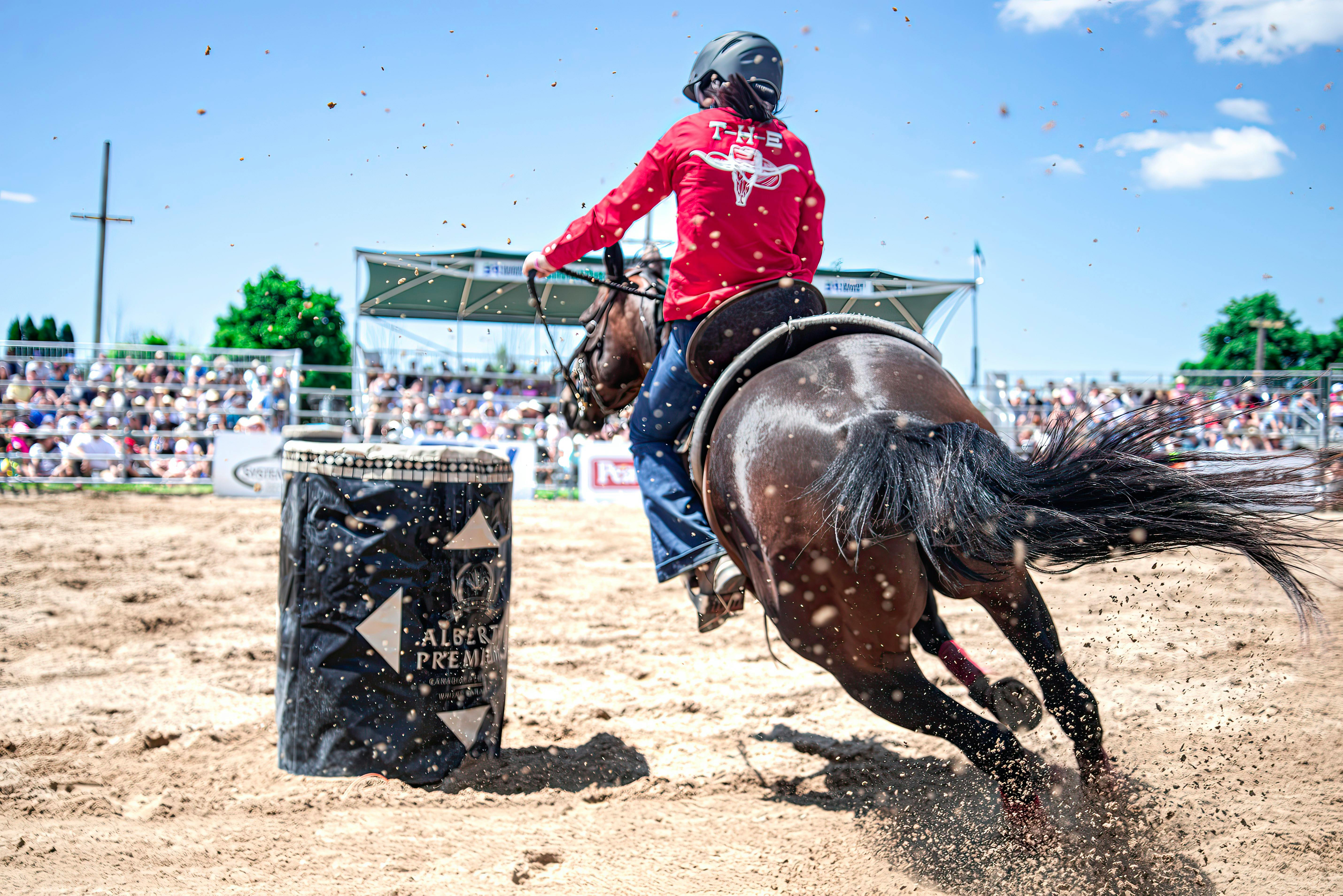 back view of a person horseback riding in a competition