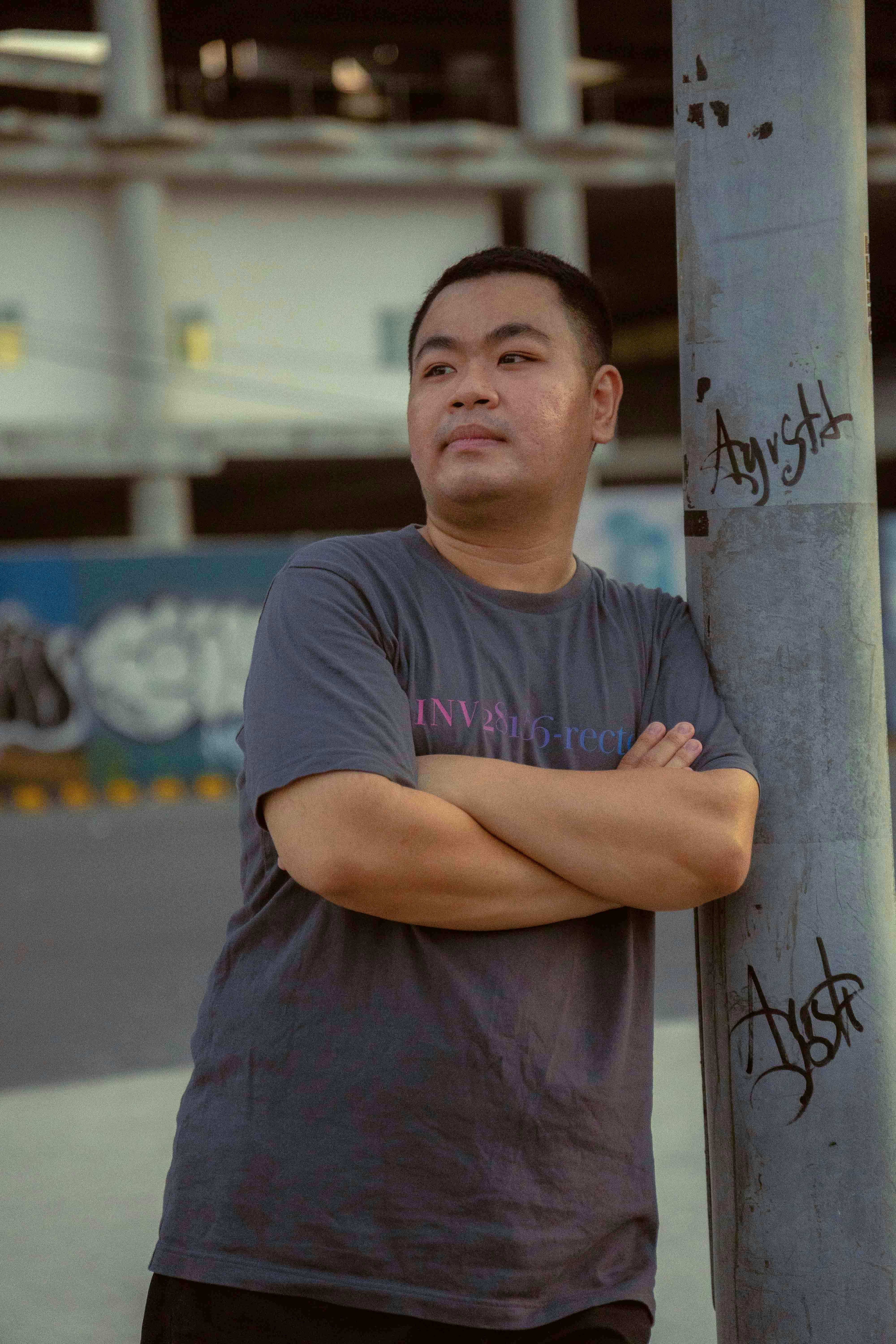 Portrait of a man in an urban setting with street art in Ho Chi Minh City.