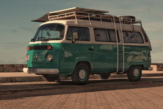 Iconic green vintage Volkswagen camper van parked by the sea, ideal for travel enthusiasts.