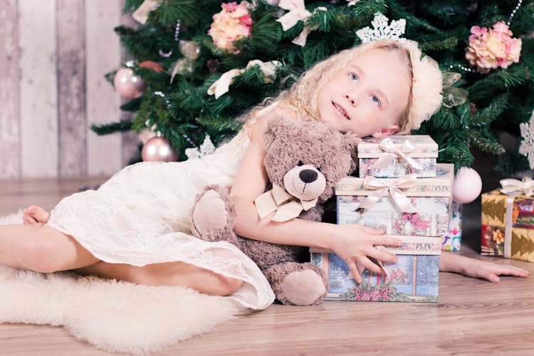 Girl Lying Beside Three Gift Boxes