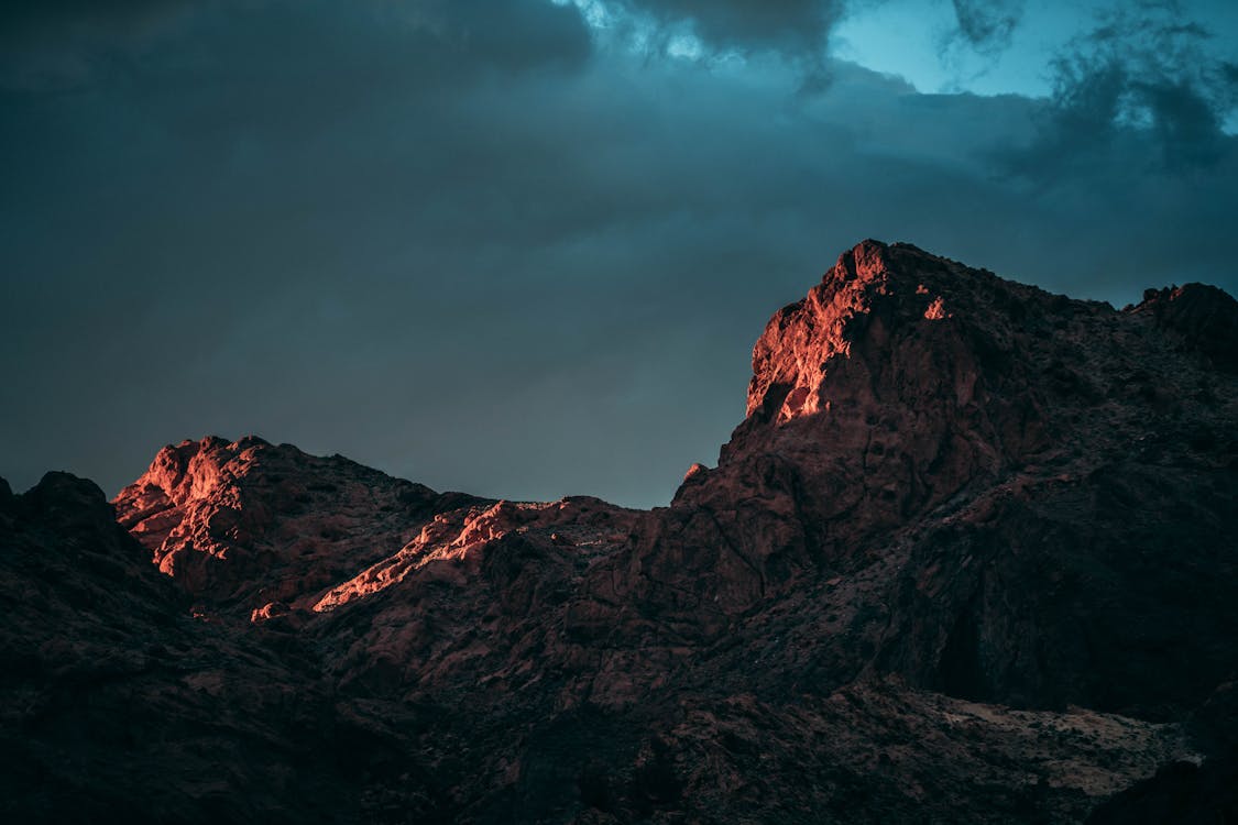 Fotografi Sudut Rendah Gunung Batu Di Bawah Langit Berawan