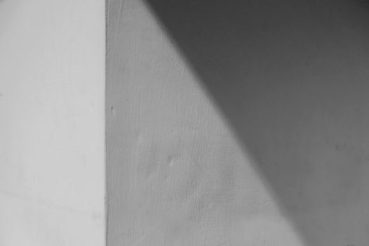 Abstract view of a cornered concrete wall with light and shadow play.