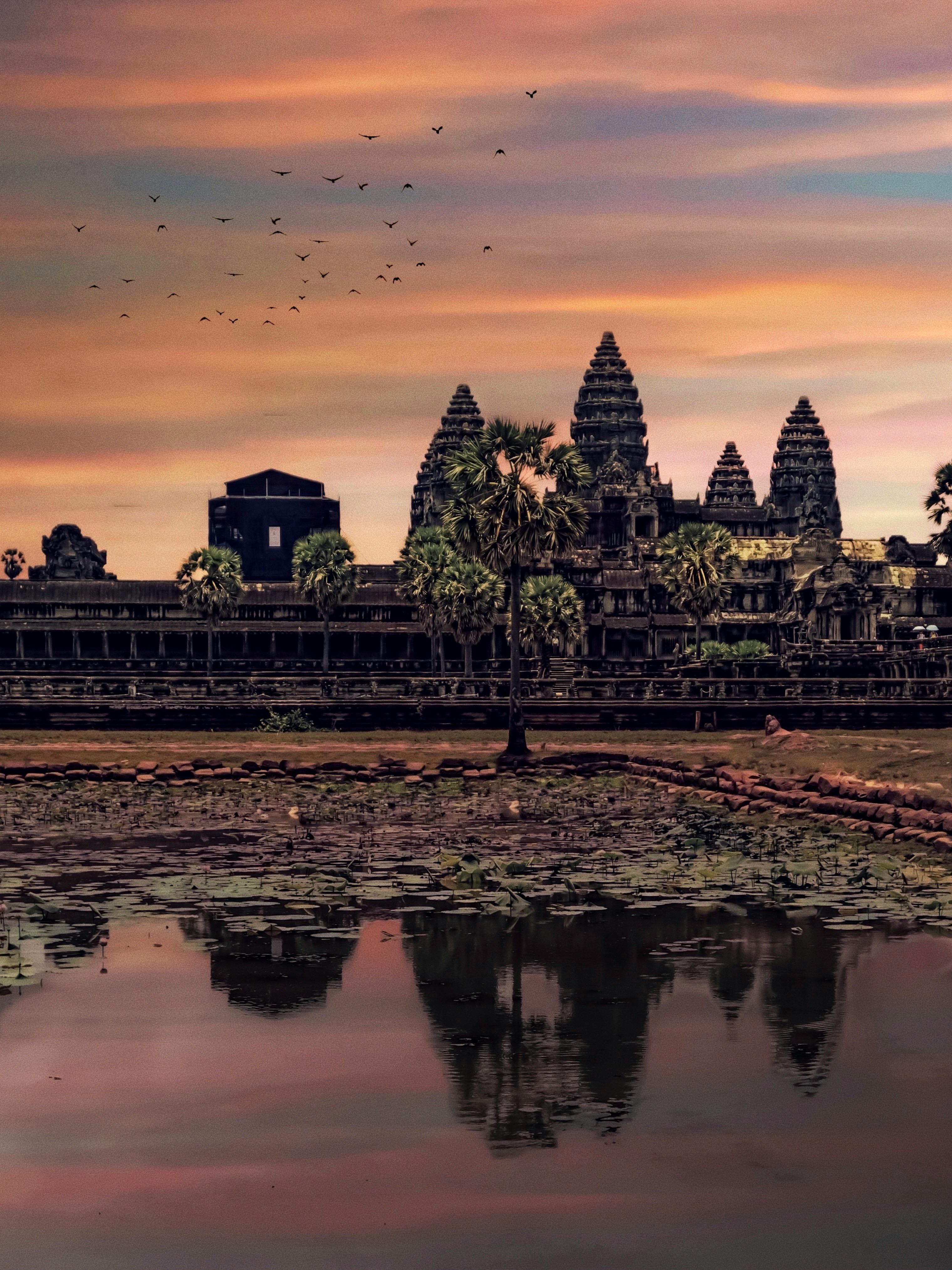 view of angkor wat in cambodia during sunset
