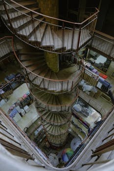 High angle view of spiral staircase in a multi-story urban building.