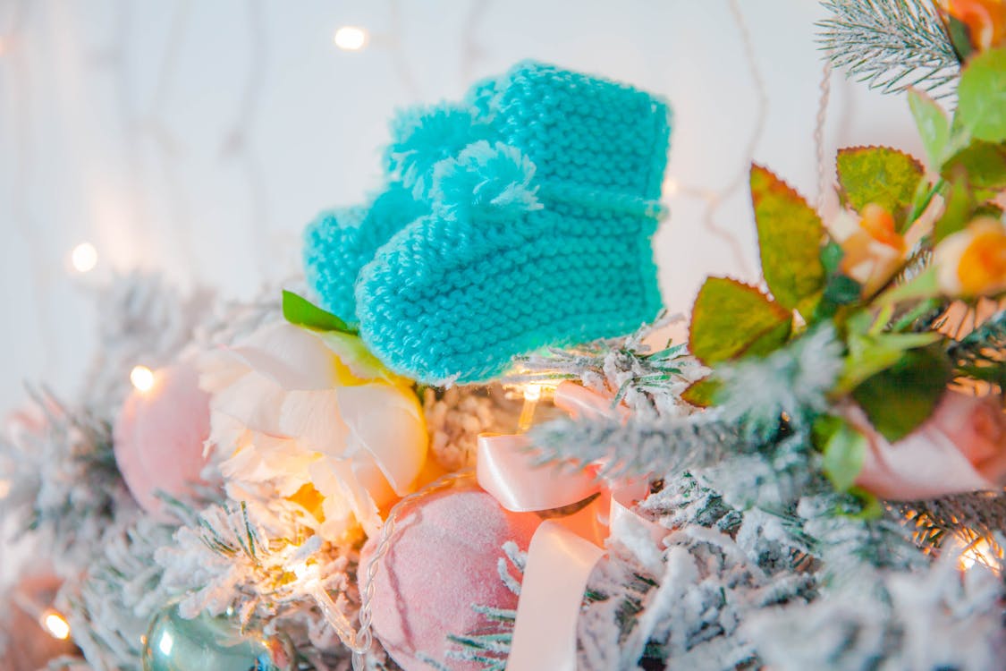 Free Pair of Teal Knit Sock Hanging on Christmas Tree Stock Photo