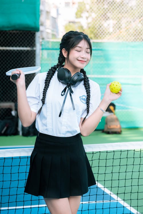 Girl Standing on a Tennis Court 