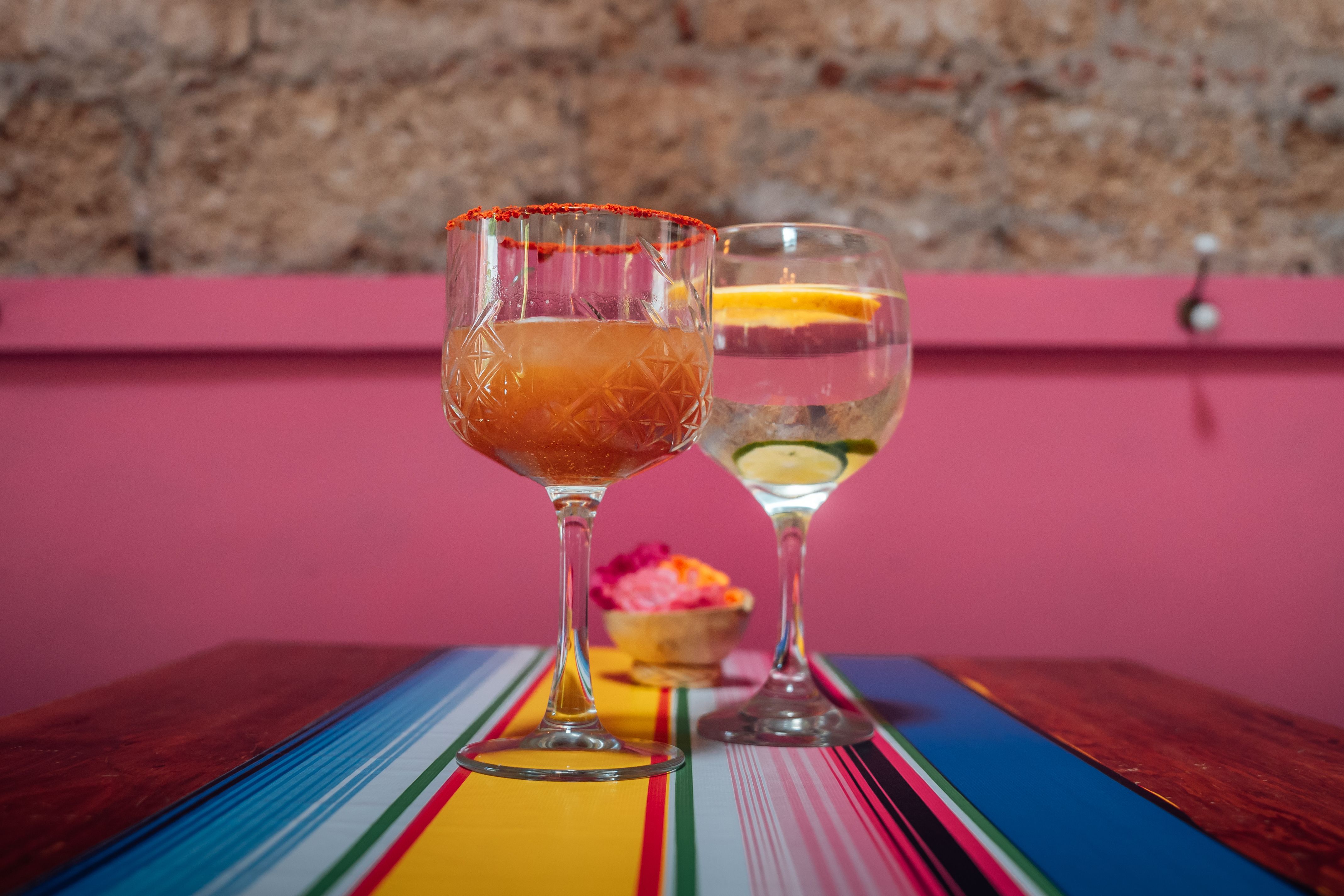 Mezcal cocktails and mixology tools on a wooden table