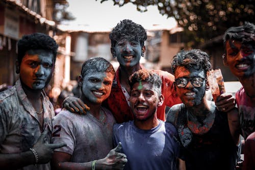 Free Group of men with faces and body covered with coloured powder Stock Photo