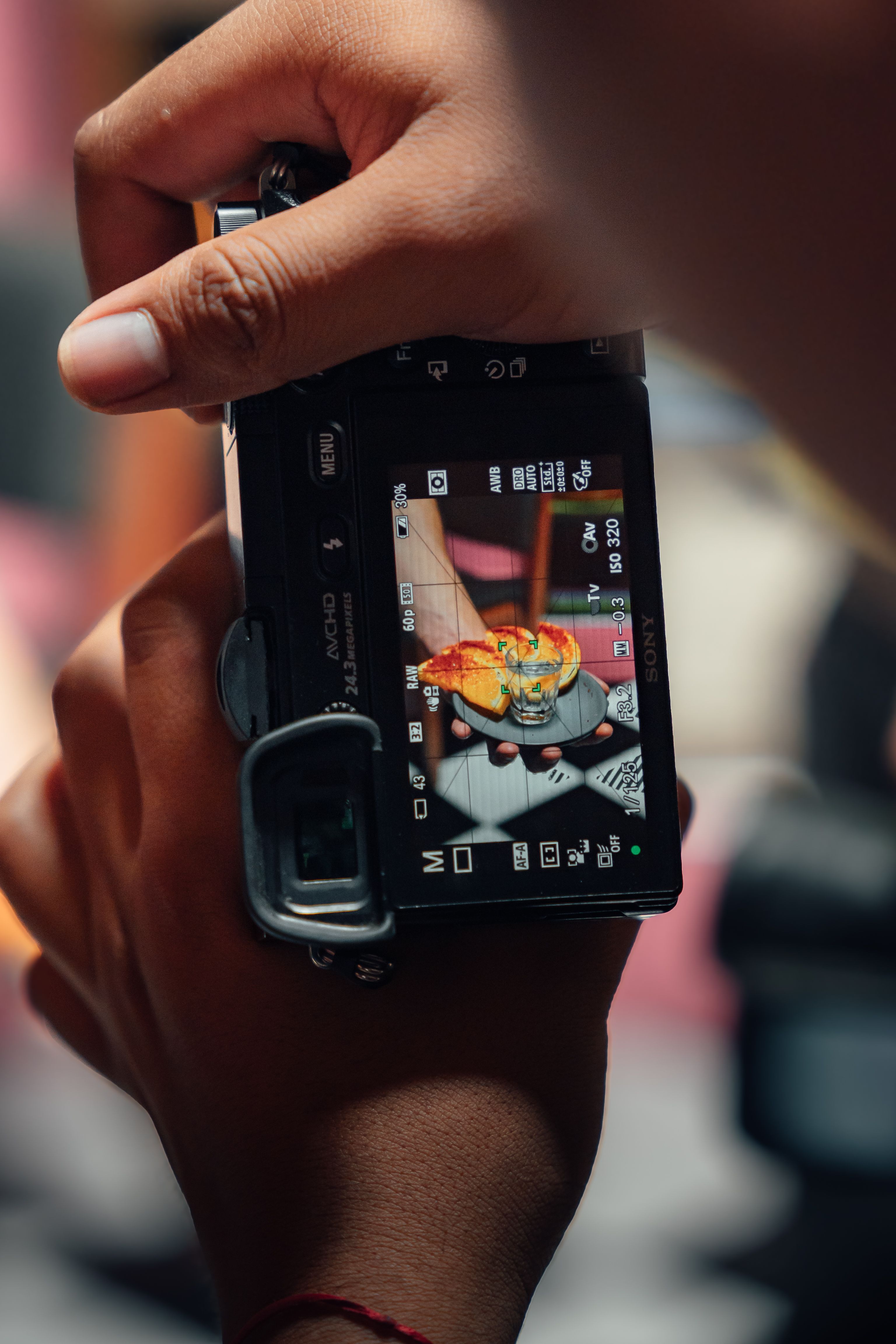 A close-up shot of a person taking a photo of a plated dish, showcasing food photography in action.