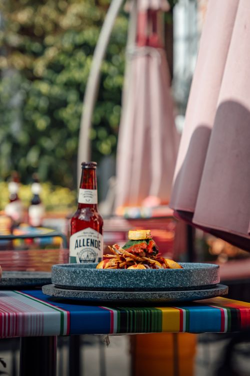 Free Vibrant outdoor setting with Mexican food and beer in Ciudad de México. Stock Photo